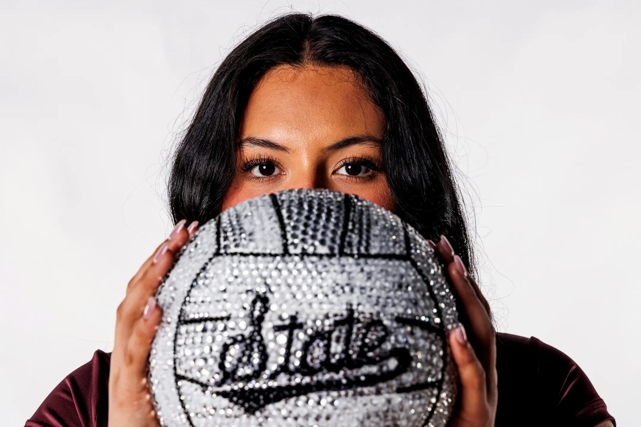 Mele posing with a jeweled volleyball at Mississippi State University in 2024